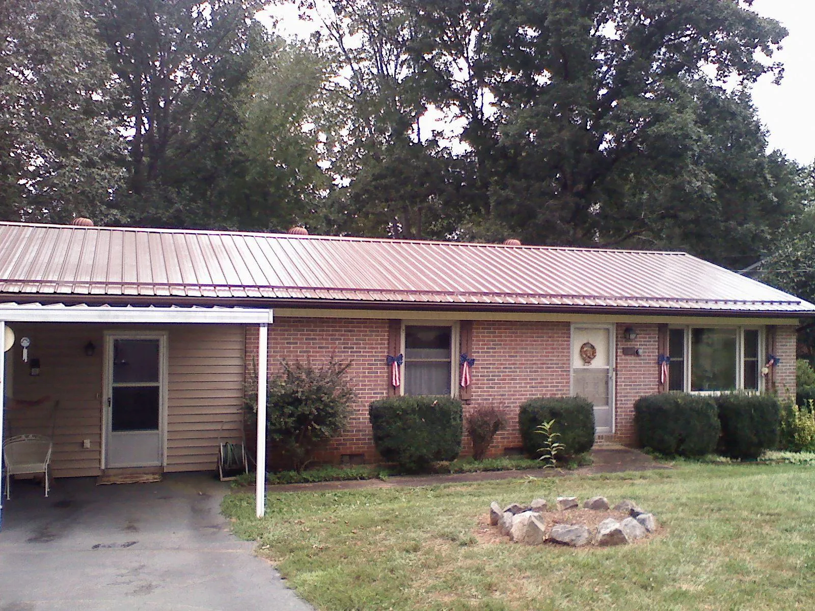 Bronze metal roof and carport on a brick ranch home — Roof Repair work by our crew in Green Lane