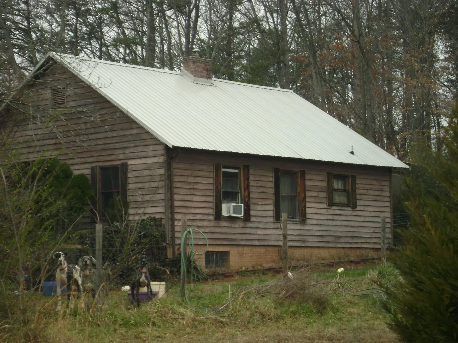 White metal roof on an old wood sided farmhouse in Green Lane
